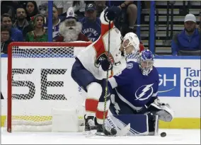  ?? CHRIS O’MEARA - THE ASSOCIATED PRESS ?? Florida Panthers center Aleksander Barkov (16) works for the puck in front of Tampa Bay Lightning goaltender Andrei Vasilevski­y (88) during the second period of an NHL hockey game Monday, Dec. 23, 2019, in Tampa, Fla.