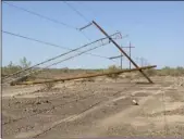  ?? PHOTO COURTESY OF IID ?? Power poles “downed” along the Imperial Irrigation District's F-line by the Sept. 8 storm.