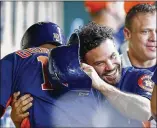  ?? BOB LEVEY / GETTY IMAGES ?? Jose Altuve gives Yuli Gurriel a hug after Gurriel smacked a grand slam in the second inning of an 11-3 Astros win Sunday in Houston. The slam was one of three hits for Gurriel.