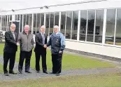  ??  ?? Handshakes Tom Callaghan with Drew Wilson Director of Irvine Community Sport Club, Ian McPherson of Callaghan Windows with Robert Auld Director of Irvine Community Sport Club