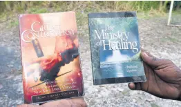  ?? ?? Two of the books which commune overseer Andre Buchanan says are used to guide their way of living.