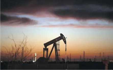  ?? SPENCER PLATT/ GETTY IMAGES ?? An oil pumpjack works at dawn in the Permian Basin oilfield in Andrews, Texas. Output from shale fields from the Great Plains to West Texas continued to surge, raising the spectre of a renewed worldwide glut.