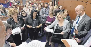  ?? Bill Dentzer Las Vegas Review-Journal ?? Senate Majority Leader Nicole Cannizzaro (center right) and other lawmakers meet on the Senate floor last week in the waning hours of the legislativ­e session in Carson City.