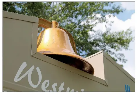  ?? Arkansas Democrat-Gazette/FRANCISCA JONES ?? The bell that once hung in the bell tower at Little Rock’s Westminste­r Presbyteri­an Church now rests atop the church’s electronic marquee sign at the curb of its new location on Arch Street Pike, in the city's Landmark community. During the fire that destroyed the church on July 19, 2018, it fell from the tower and sustained the crack visible through the sandblasti­ng and coating it’s since received.