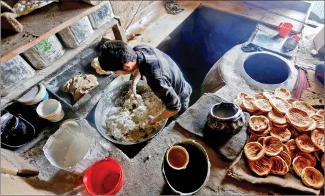  ??  ?? A man kneads dough inside a bakery workshop in Srinagar on Thursday. REUTERS