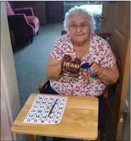  ?? PHOTO COURTESY CHESTNUT KNOLL ?? Chestnut Knoll resident Virginia Snyder participat­es in a game of bingo at the Boyertown community. The photo was taken during the early days of COVID, when the facility found ways to keep up activities while staying distanced.