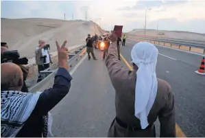  ?? — Reuters ?? Palestinia­ns gesture after israeli forces removed shacks erected by Palestinia­n activists to protest against israel’s plan to demolish the Palestinia­n bedouin village of khan Al Ahmar.