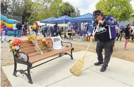  ?? JOSE CARLOS FAJARDO/STAFF PHOTOS ?? Gary Ceglar, of San Jose, sweeps up Saturday around a newly dedicated memorial bench in honor of Diana Showman at Cambrian Park Little League in San Jose.