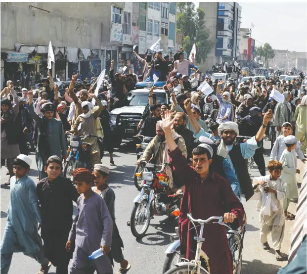  ?? AFP VIA GETTY IMAGES ?? Afghans filled the streets in Kandahar Tuesday to celebrate the U.S. military withdrawal from their country, ending a brutal 20-year war.