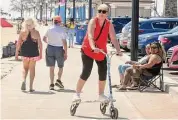  ?? Ned Gerard/Hearst Connecticu­t Media ?? A woman rides a scooter at Seaside Park in Bridgeport. Bridgeport officials are increasing the police presence at the park.