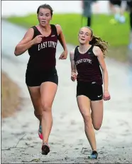  ?? SEAN D. ELLIOT/THE DAY ?? East Lyme’s Claire Mason, right, passes teammate Rasa Kirvelevic­ius near the finish line for second placing during the Vikings’ 24-31 win over NFA on Tuesday in Norwich.