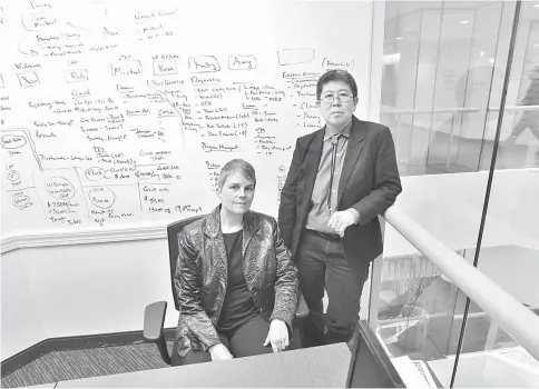  ??  ?? Graham (left) and Kwong work from a rented one-room office that is the headquarte­rs of Trek Therapeuti­cs, a startup focused on making affordable medication­s. Kwong is chief executive and Graham is vice president of medical and government affairs. —...