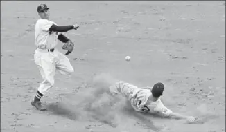 ?? ASSOCIATED PRESS FILE PHOTOS ?? Boston Red Sox Hall of Famer Bobby Doerr, who frequently led AL second basemen in double plays, put-outs and assists, turns a double play as Detroit Tigers’ Steve Souchock tries for second May 20, 1951.
