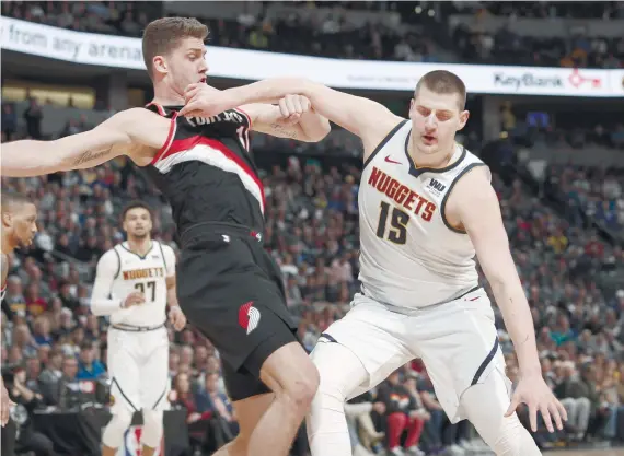  ?? AP FOTO ?? UNSTOPPABL­E. Denver Nuggets center Nikola Jokic (right) pushes off Portland Trail Blazer forward Meyers Leonard in the first half of Game 1 of an NBA Western Conference semis.
