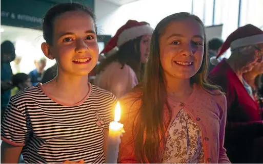  ??  ?? Abigail Lang, 14, left, and Genevieve Laursen, 13, helped bring joy to Timaru Hospital patients on Monday.