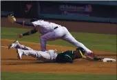  ?? MARCIO JOSE SANCHEZ — THE ASSOCIATED PRESS ?? Houston Astros first baseman Yuli Gurriel, top, forces out the A’s Marcus Semien at first base after Tommy La Stella lined out for a double play during the third inning of Game 4 of the American League Division Series on Thursday.