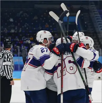  ?? MATT SLOCUM — THE ASSOCIATED PRESS ?? For more Olympic stories, commentary, photos, results, schedules and more, visit
United States players celebrate after scoring during Saturday's victory over rival Canada in a preliminar­y-round men's hockey game at the 2022 Winter Olympics. The surprising Americans are now 2-0 and lead their group.