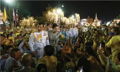  ?? Photograph: Jack Taylor/AFP/Getty Images ?? King Maha Vajiralong­korn and Queen Suthida greet supporters outside the Grand Palace in Bangkok on Sunday.