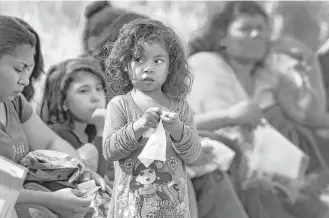  ?? Bob Owen / San Antonio Express-News file ?? Central American families and children, like this little girl detained last November after crossing the Rio Grande near Rincon Village, make up the fastest-growing demographi­c of migrants here illegally, one-quarter of all apprehensi­ons at the southern...