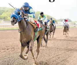  ?? KENYON HEMANS/PHOTOGRAPH­ER ?? MAHOGANY, with Dane Dawkins aboard, wins the 9th race ahead of stablemate FATHER PATRICK at Caymanas Park yesterday.