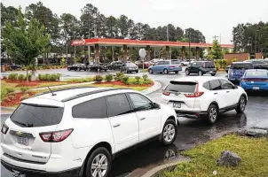  ?? Sean Rayford / Getty Images ?? Motorists wait at a gas station Wednesday in Fayettevil­le, N.C., as most stations in the area along Interstate 95 were without fuel following the Colonial Pipeline hack.