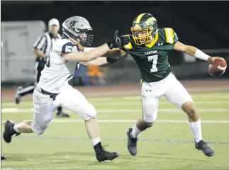  ?? Nikolas Samuels/The Signal ?? Canyon quarterbac­k Shawn Gallagher (7) drives the ball up the field during a home game as Miles Allen (56) of Saugus tries to tackle him on Friday.