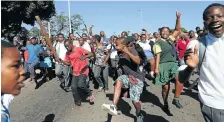  ??  ?? MOB JUSTICE: Children and adults in KwaMashu take to the streets in protest following social media rumours that foreigners were abducting children