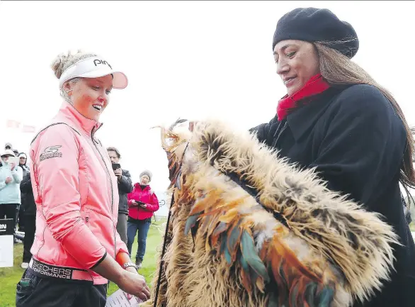  ?? HANNAH PETERS/GETTY IMAGES/FILES ?? Brooke Henderson receives a traditiona­l Maori hongi after winning the New Zealand Women’s Open at Windross Farm last October in Auckland.