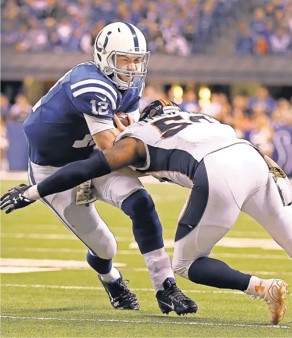  ?? MATT KRYGER, THE INDIANAPOL­IS STAR ?? Colts quarterbac­k Andrew Luck, left, is hit by the Broncos’ Danny Trevathan during a game in which he suffered a lacerated kidney.