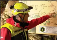  ?? (AP/Pop TV) ?? A rescuer inspects the map of Krizna Jama cave near Grahovo, Slovenia, on Sunday, Jan. 7, 2024.