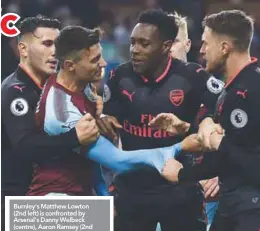  ??  ?? Burnley’s Matthew Lowton (2nd left) is confronted by Arsenal’s Danny Welbeck (centre), Aaron Ramsey (2nd right) and Laurent Koscielny before a penalty was awarded to Arsenal during their English Premier League match at Turf Moor in Burnley yesterday. –