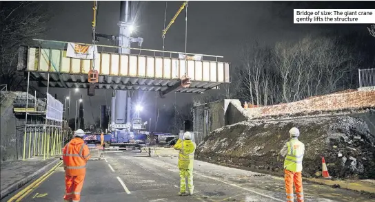  ??  ?? Bridge of size: The giant crane gently lifts the structure