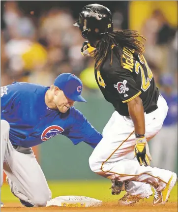  ?? Matt Freed/Post-Gazette Chicago’s Chris Valaika tags out Andrew McCutchen as McCutchen attempted to steal second base in the sixth inning Saturday night at PNC Park. ??