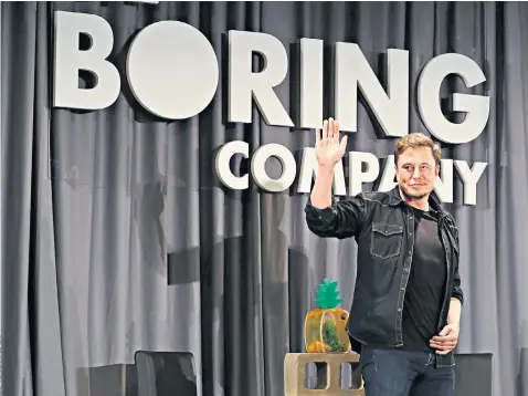  ??  ?? Elon Musk, chief executive of Tesla, arrives to speak at a Boring Company community meeting in Bel Air. The billionair­e wants to build a 150mph train network under Los Angeles