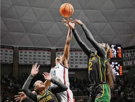  ?? Jessica Hill/AP ?? UConn’s Aubrey Griffin, center, grabs a rebound over Baylor’s Kyla Abraham, right, in the second half of a second-round college basketball game in the NCAA Tournament Monday in Storrs.