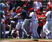  ?? RONALD MARTINEZ — GETTY IMAGES ?? The Mariners and Angels engage in a benches-clearing brawl after Seattle's Jesse Winker charged the Los Angeles dugout after being hit by a pitch in the second inning.