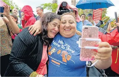  ?? SUSAN STOCKER/STAFF PHOTOGRAPH­ER ?? Reina Gomez, left, hugs Ingrid Vaca after Gomez left her check-in appointmen­t with the U.S. Immigratio­n and Customs Enforcemen­t field office in Miramar. Gomez said she has been diagnosed with a rare form of leukemia that cannot be properly treated in...