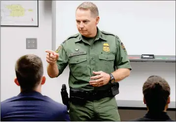  ??  ?? PORVAZNIK TALKS WITH THE EIGHT prospectiv­e U.S. Border Patrol agents.