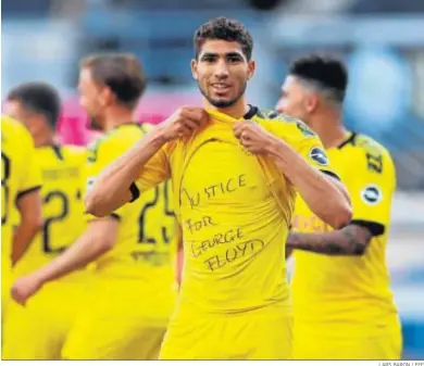  ?? LARS BARON / EFE ?? El madridista Achraf, cedido en el Borussia Dortmund, reclama justicia para George Floyd.