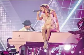  ??  ?? JENNIFER LOPEZ performs a Motown tribute onstage at the Grammy Awards on Sunday. The Latina artist has received criticism on social media for her act.