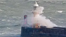  ?? GARETH FULLER/PA ?? Waves crash over a lighthouse on the harbour wall in Dover, yesterday. Forecaster­s have warned of heavy rain and high winds this weekend.