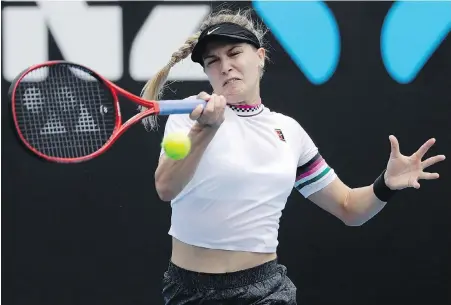  ??  ?? Canada’s Eugenie Bouchard blasts a forehand return to China’s Shuai Peng in Melbourne on Monday.