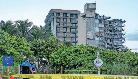  ??  ?? MIAMI Dade police officers guard the entrance to the partially collapsed 12-storey condominiu­m building in Surfside, Florida, yesterday. Miami Dade Fire Rescue officials said more than 80 units collapsed at the condominiu­m building near 88th Street and Collins Avenue just north of Miami Beach. | EPA