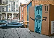  ?? Robert Bumsted / Associated Press ?? Police in Jersey City, N.J., with help from Amazon, are using dummy boxes with GPS tracking devices to try to catch thieves this holiday season.