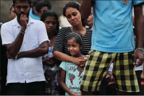 ?? AP/MANISH SWARUP ?? The mother and sister of Dhami Brandy, 13, mourn at her funeral Thursday in Negombo, Sri Lanka. Dhami was among the victims of Easter Sunday’s bombing at St. Sebastian Church.