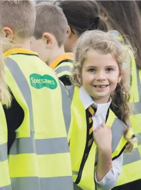  ??  ?? School children try their new Specsavers high visibility vests