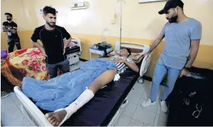  ?? Reuters ?? An injured protester receives treatment at a hospital in Basra on wednesday. —