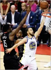  ??  ?? Golden State Warriors guard Stephen Curry (30) drives to the basket as Houston Rockets center Clint Capela (15) defends during the first half of Game 2 of the NBA basketball playoffs Western Conference finals Wednesday, May 16, in Houston. AP PHOTO BY...