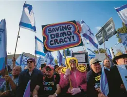  ?? OHAD ZWIGENBERG/AP ?? Israelis protest against plans by Prime Minister Netanyahu’s government to overhaul the legal system Monday outside the parliament, or Knesset, in Jerusalem.