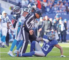  ?? JIM O’CONNOR, USA TODAY SPORTS ?? An official stands between Giants wide receiver Odell Beckham Jr., right, and Panthers cornerback Josh Norman.